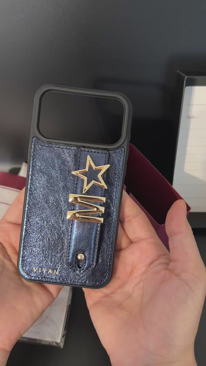 Personalized leather iPhone 17 Pro Max case — choose letter and symbol charms, two free. Genuine leather, soft-touch lining. Free US shipping over $70.