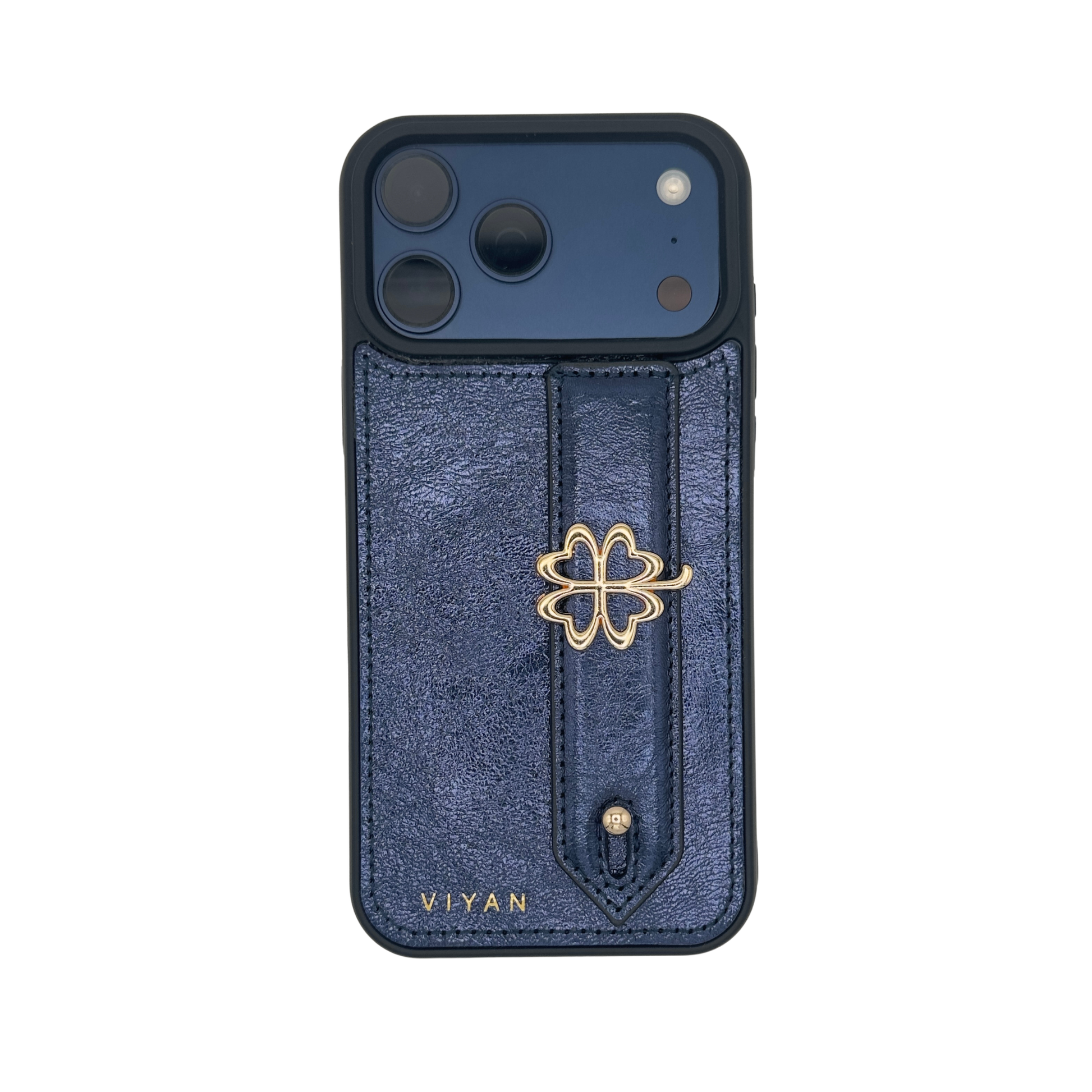 Gold-tone clover charm on a Navy VIYAN leather iPhone case, shown at an angle #gold